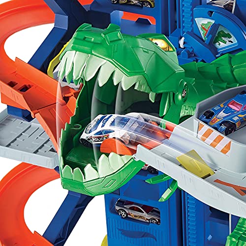 Hot Wheels Megagaraje con T-Rex Robótico - Ascensor y 4 Niveles - Plazas para 100 Coches 1:64 - 2 Coches 1:64 Incluidos - Regalo para Niños de 3+ Años